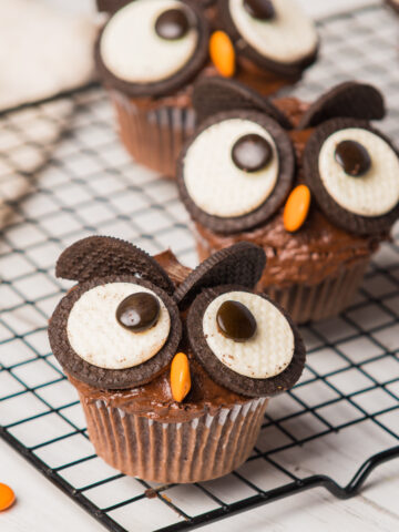 3 Owl Cupcakes with Oreos on a cooling rack